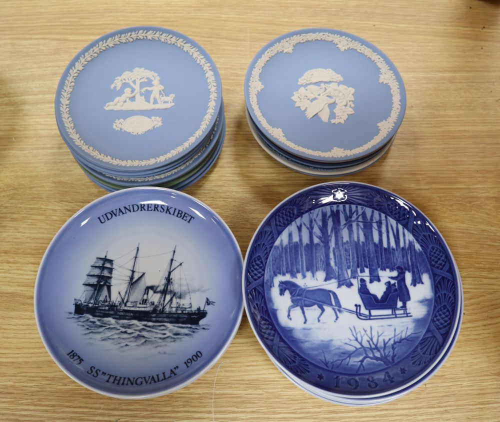 Sixteen Wedgwood jasper mother plates, ten Royal Copenhagen Christmas plates and twelve Limoges Paris view plates and a B & G plate